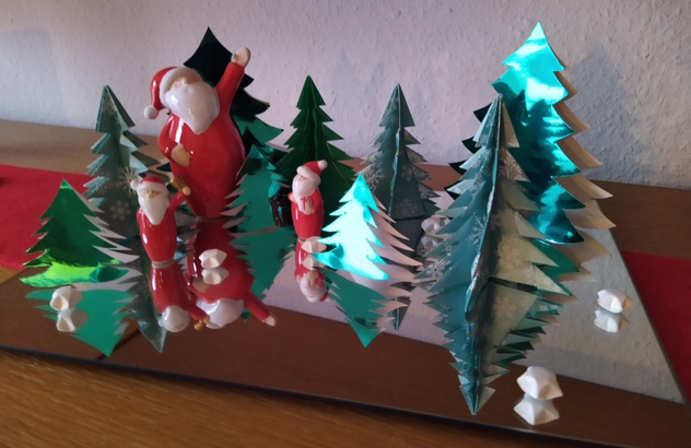 Santa Claus dolls in a forest of Evergreens